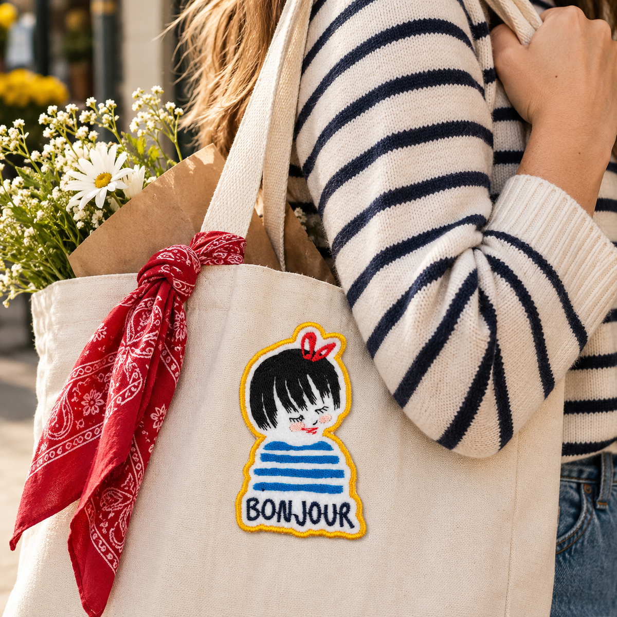Bonjour Girl embroidered patch styled on a canvas tote