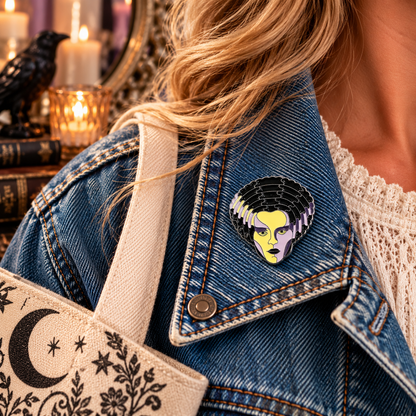 Bride of Frankenstein inspired enamel pin worn on a denim jacket