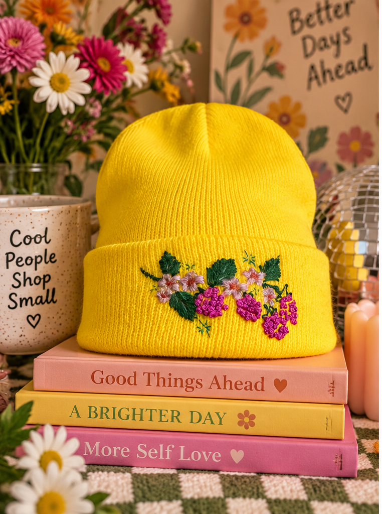 Bright yellow hand-embroidered berry floral beanie styled product photo