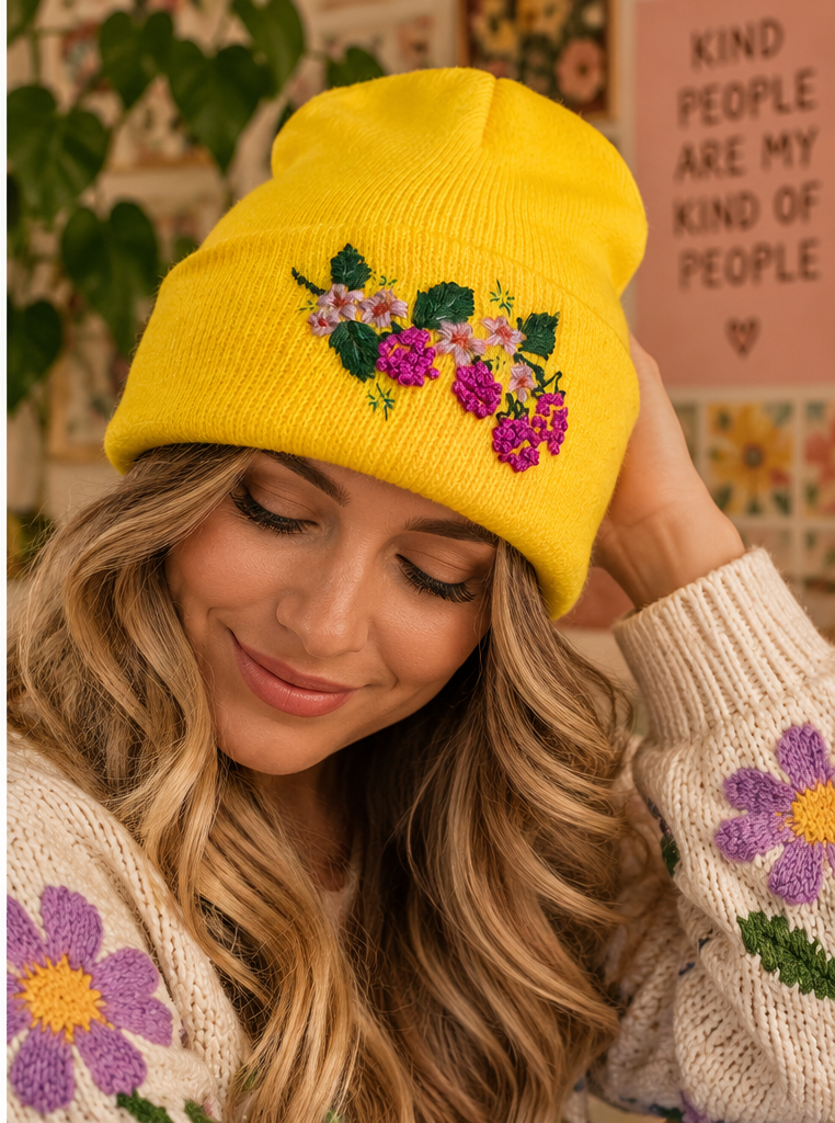 Woman wearing bright yellow hand-embroidered berry floral beanie