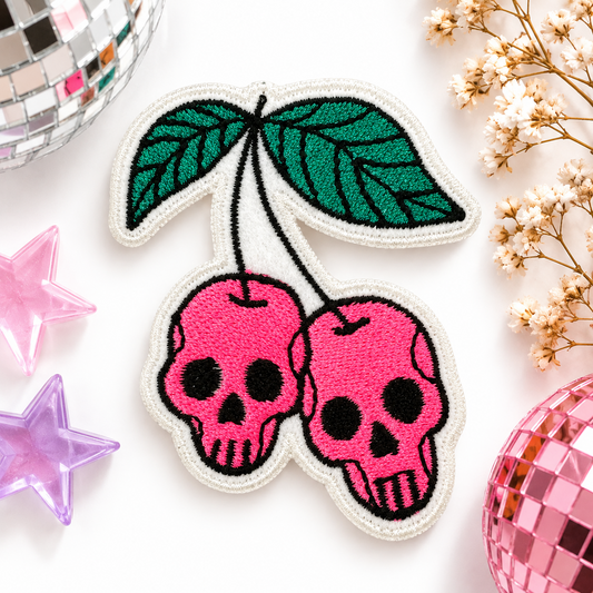Cherry skulls embroidered patch with bright pink skull cherries and green leaves