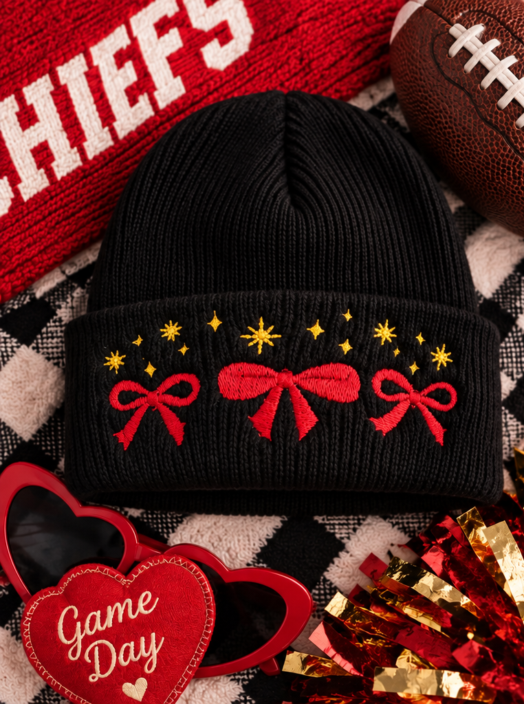 Black embroidered beanie with red bows and gold stars, styled for Kansas City game day.