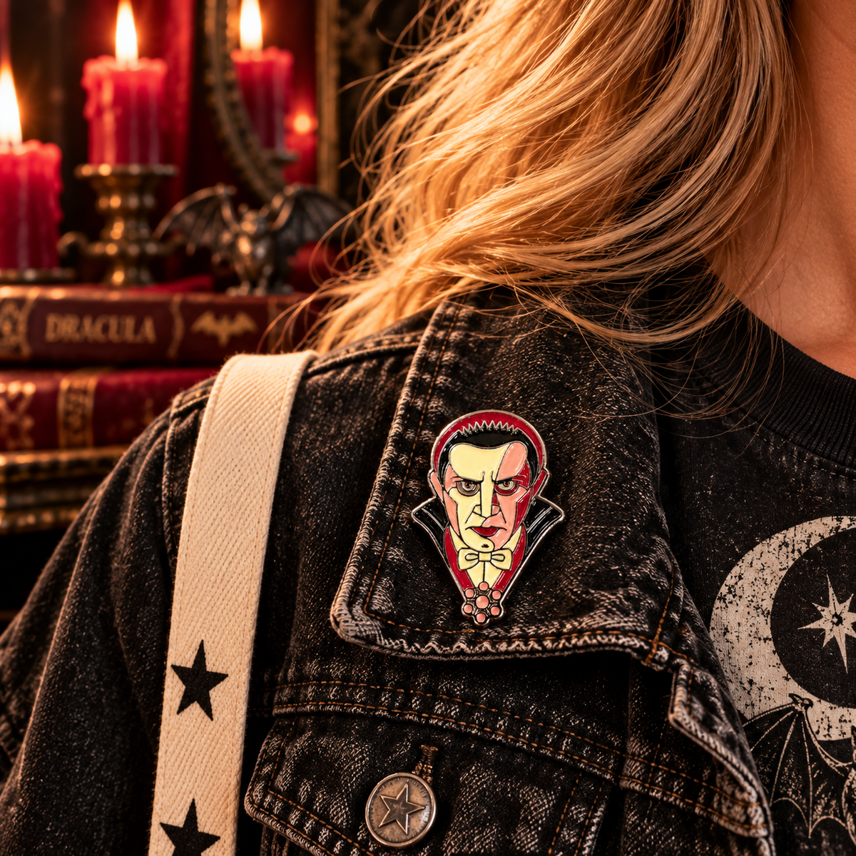 Classic vampire enamel pin worn on a black denim jacket