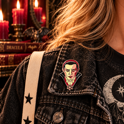 Classic vampire enamel pin worn on a black denim jacket