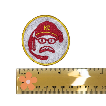 Scale photo of the KC coach patch next to a ruler to show size

