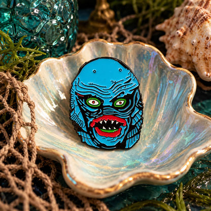 Blue retro lagoon creature enamel pin styled in a moody aquatic scene
