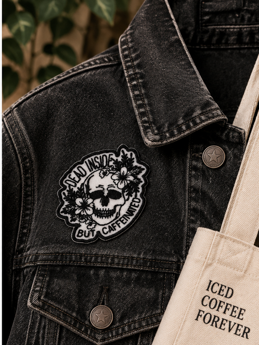 Dead Inside But Caffeinated embroidered skull patch styled on a black denim jacket
