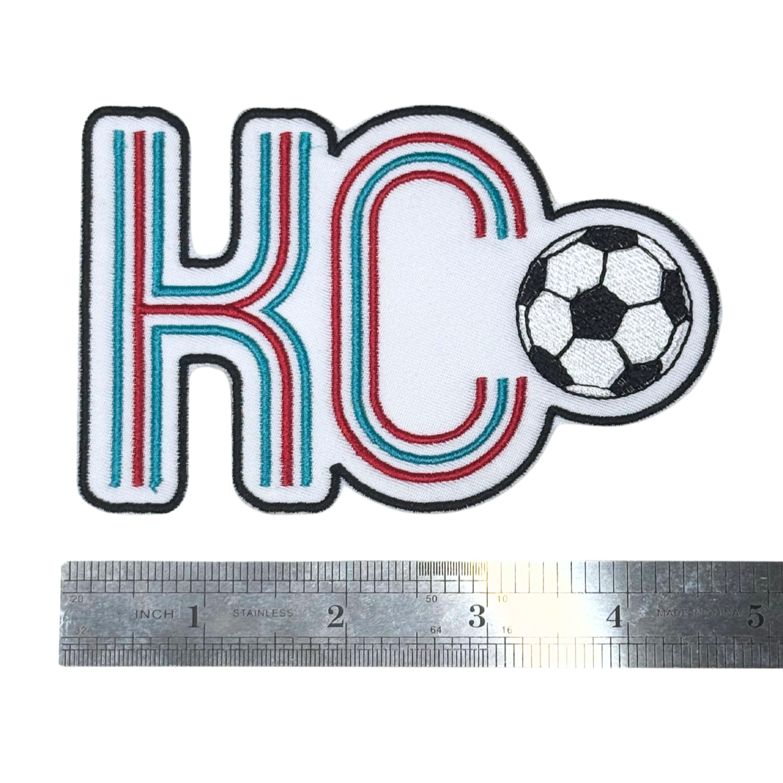 KC soccer patch next to a ruler for scale reference