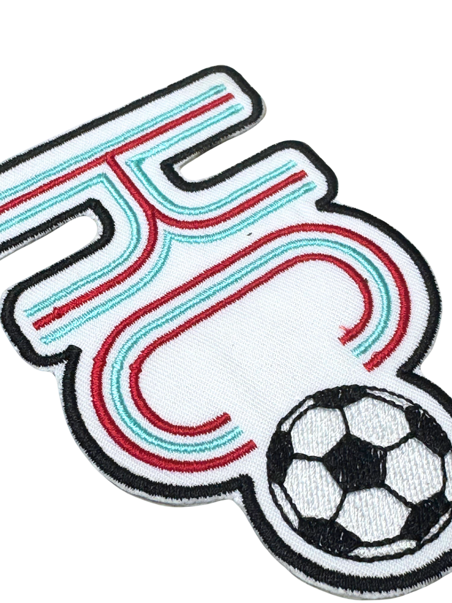 Close-up showing stitched detail of KC soccerball patch

