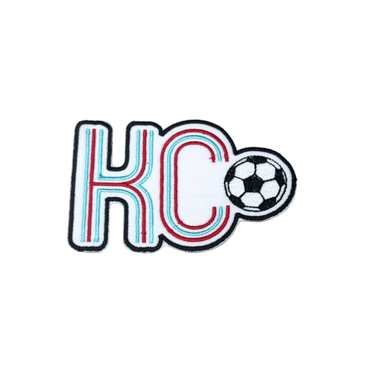 Hero image of KC soccerball patch with red, aqua, and black embroidery
