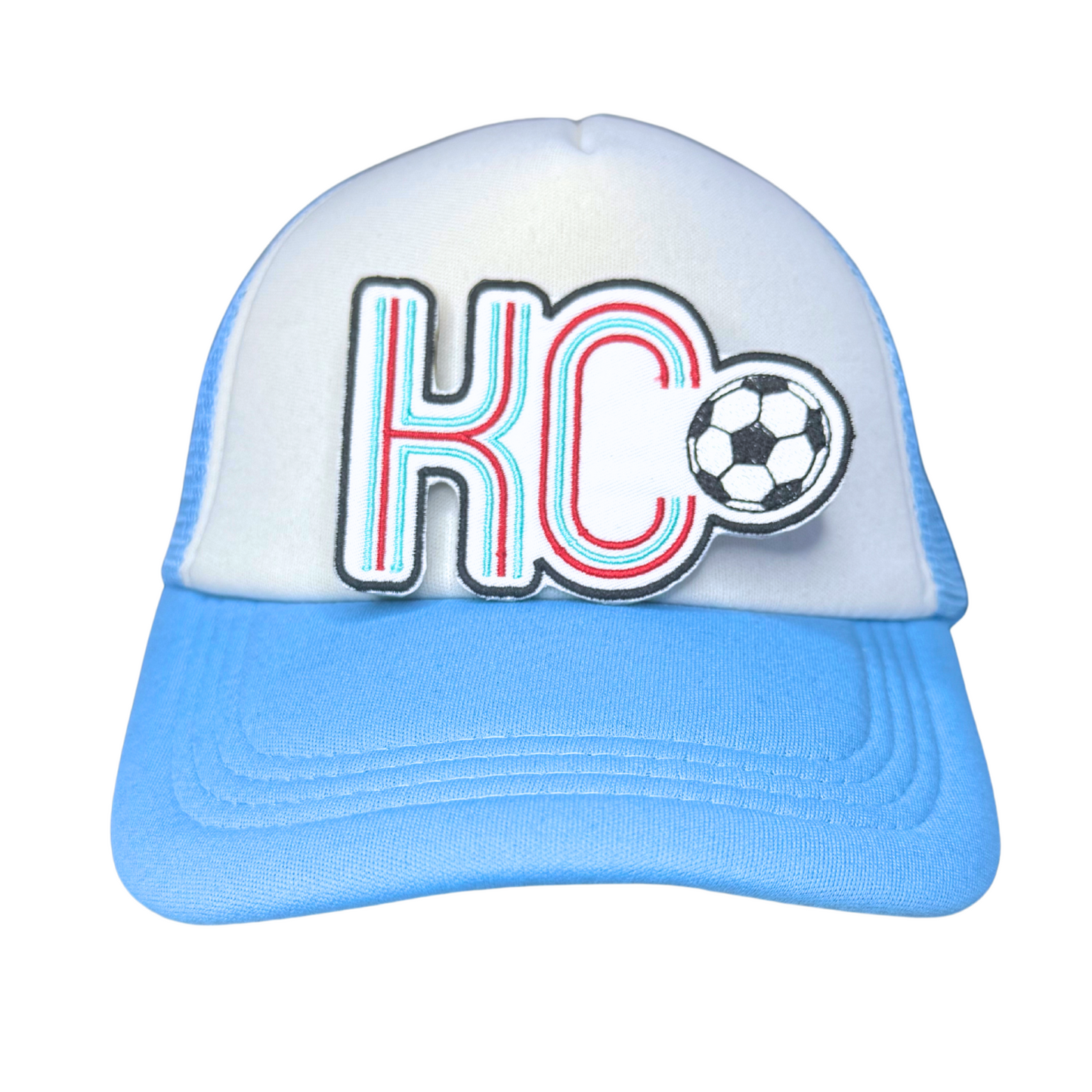 KC soccerball patch displayed on white and blue trucker hat

