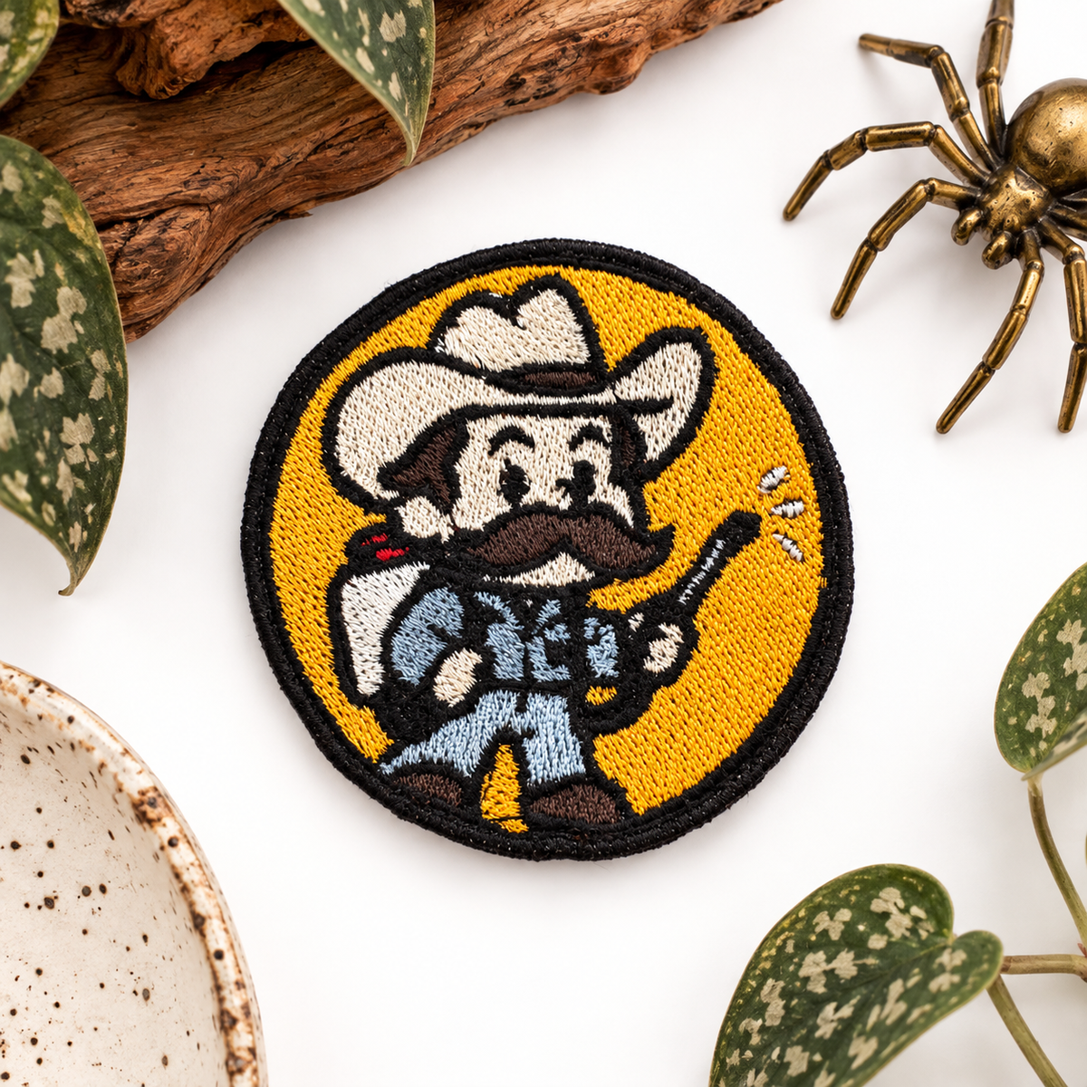 Delbert McClintock Arachnophobia embroidered patch styled on white background