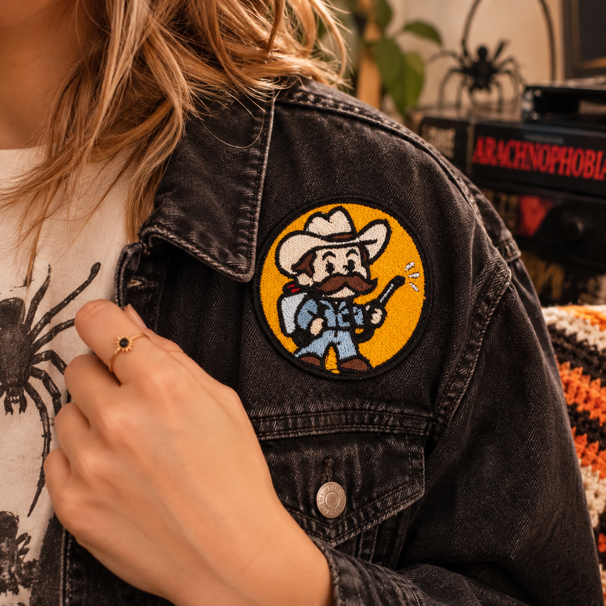 Delbert McClintock Arachnophobia patch worn on charcoal denim jacket