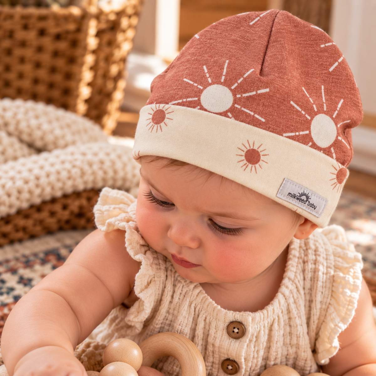 Baby wearing desert sunrise organic cotton beanie