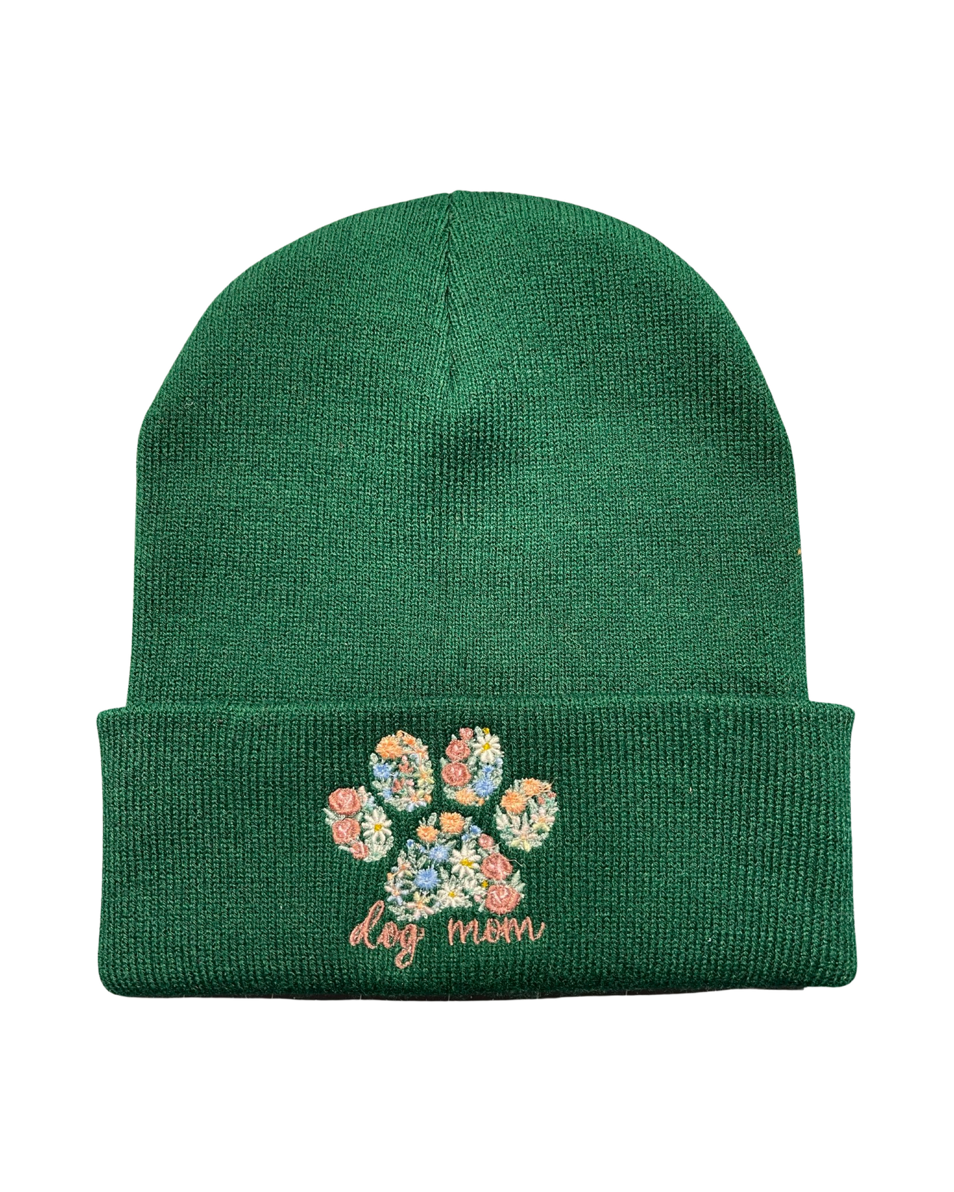 hunter green beanie embroidered with a dog paw made of various colored flowers and the words dog mom