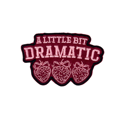 “embroidered strawberry patch with text a little bit dramatic”
