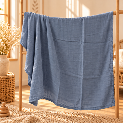 Dusty blue cotton gauze baby swaddle showing full size and drape