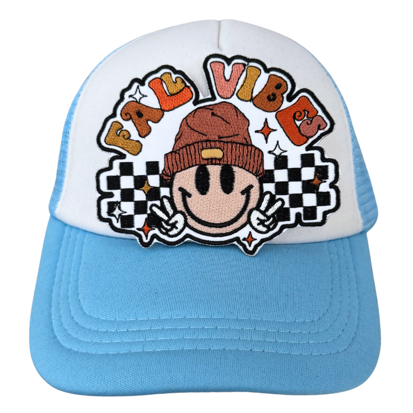 “Fall Vibes embroidered patch ironed onto white and blue trucker hat”
