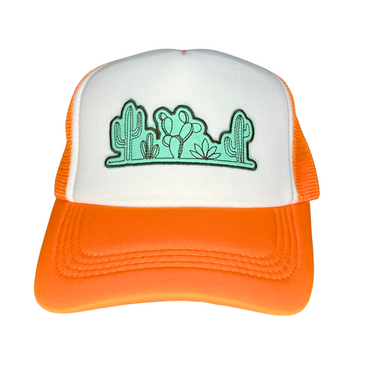 Orange and white cap with green cactus design on a white background