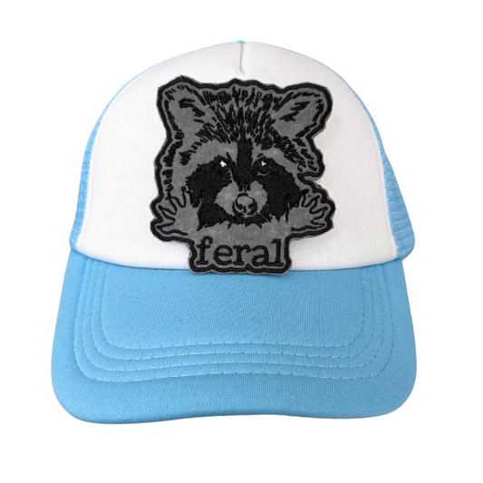 Feral raccoon patch on blue and white trucker hat
