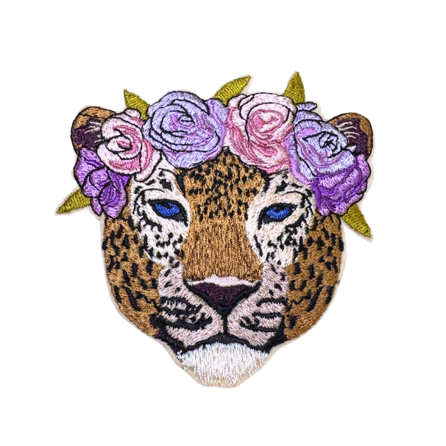 Close-up of an embroidered leopard patch with blue eyes and a floral crown of purple and pink roses.
