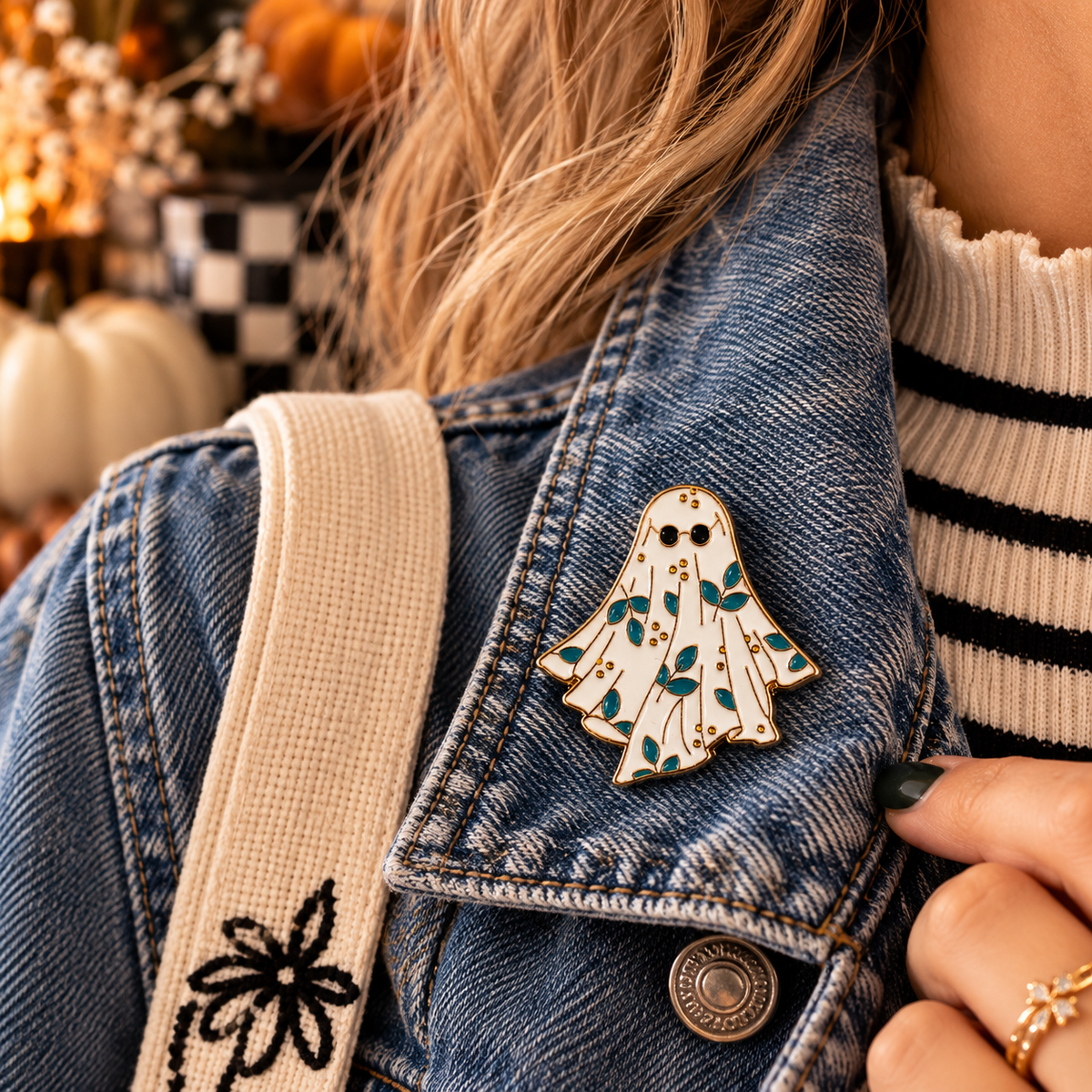 Floral ghost enamel pin styled on a denim jacket lifestyle image