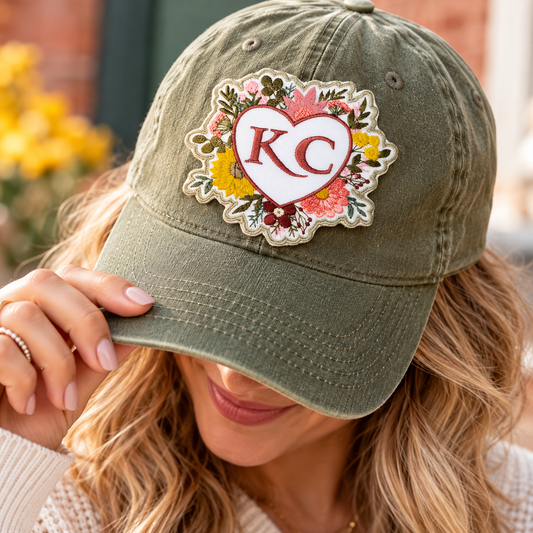 Floral KC heart embroidered patch displayed on an olive green baseball cap