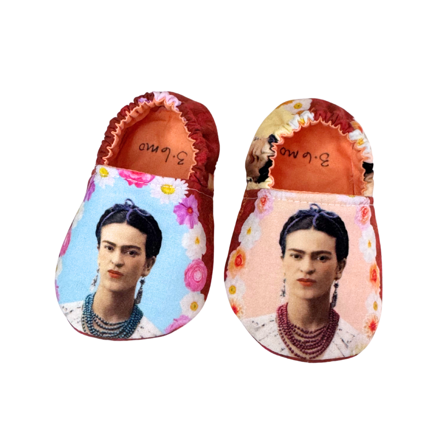 “Frida Kahlo portrait baby shoes with floral background, handmade soft sole moccasins, front view, 3–6 months”

