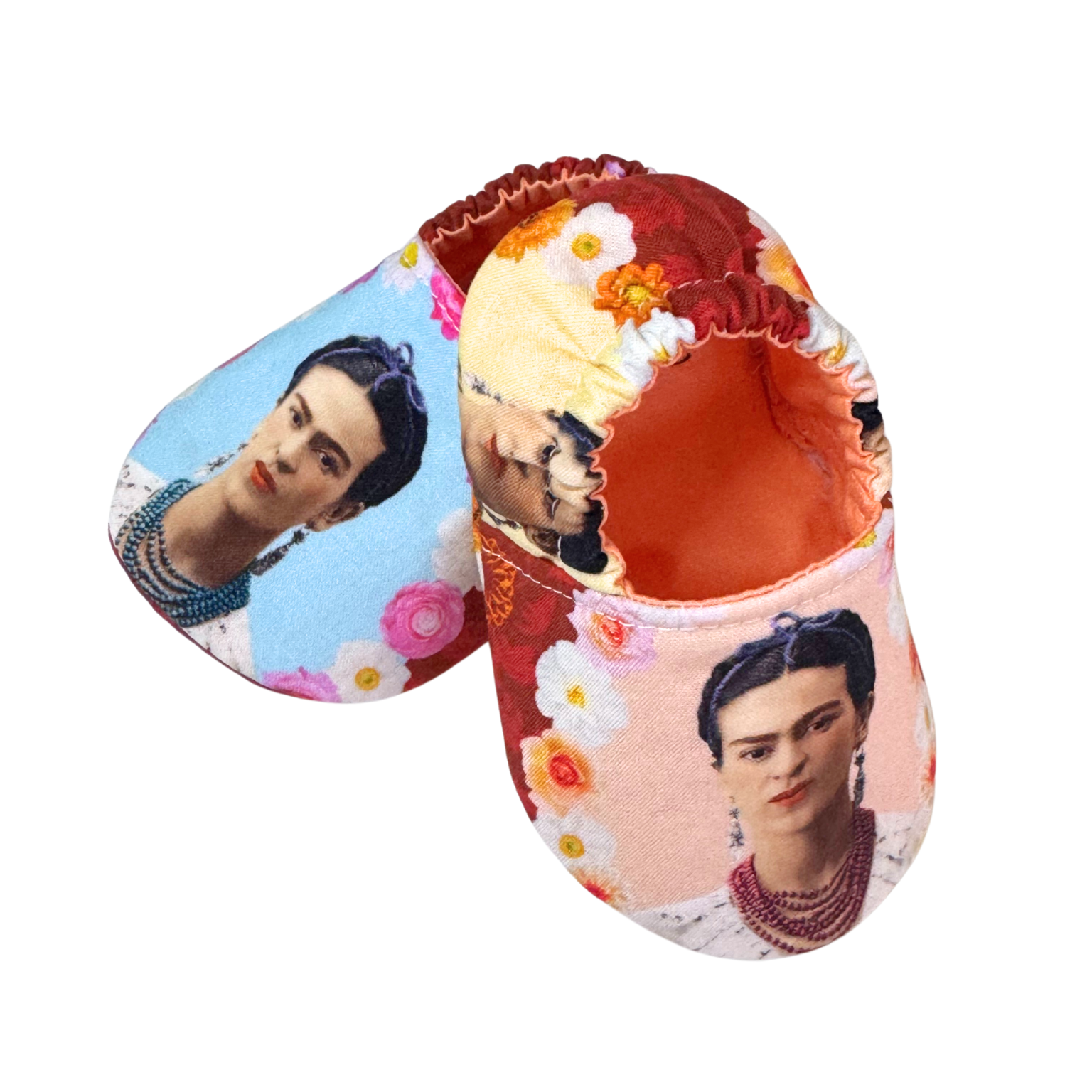 “Side view of baby moccasins with Frida Kahlo print, soft sole and orange lining, 3–6 months”

