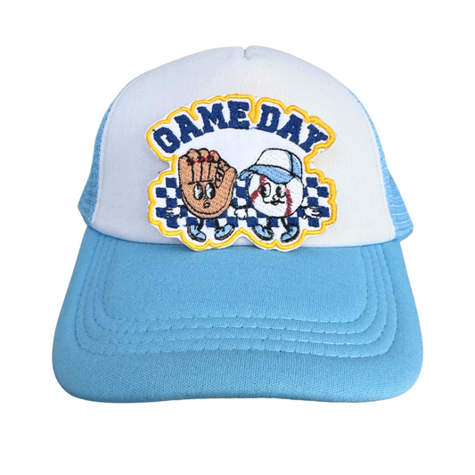 Blue and white trucker hat styled with the "Game Day" patch in KC Royals colors, perfect for baseball fans.

