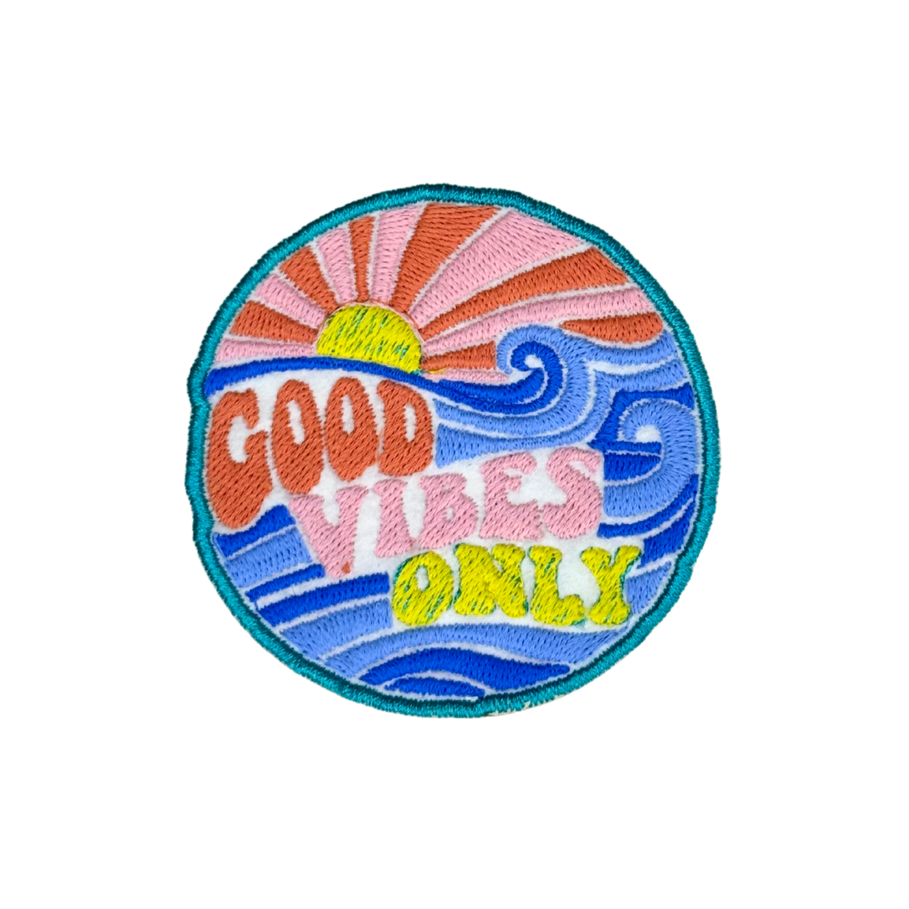 Close-up of round embroidered patch with “Good Vibes Only” text and ocean waves