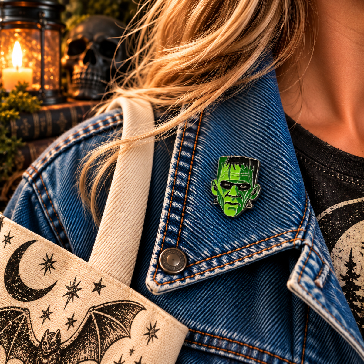 Petite green Frankenstein monster inspired enamel pin worn on a denim jacket