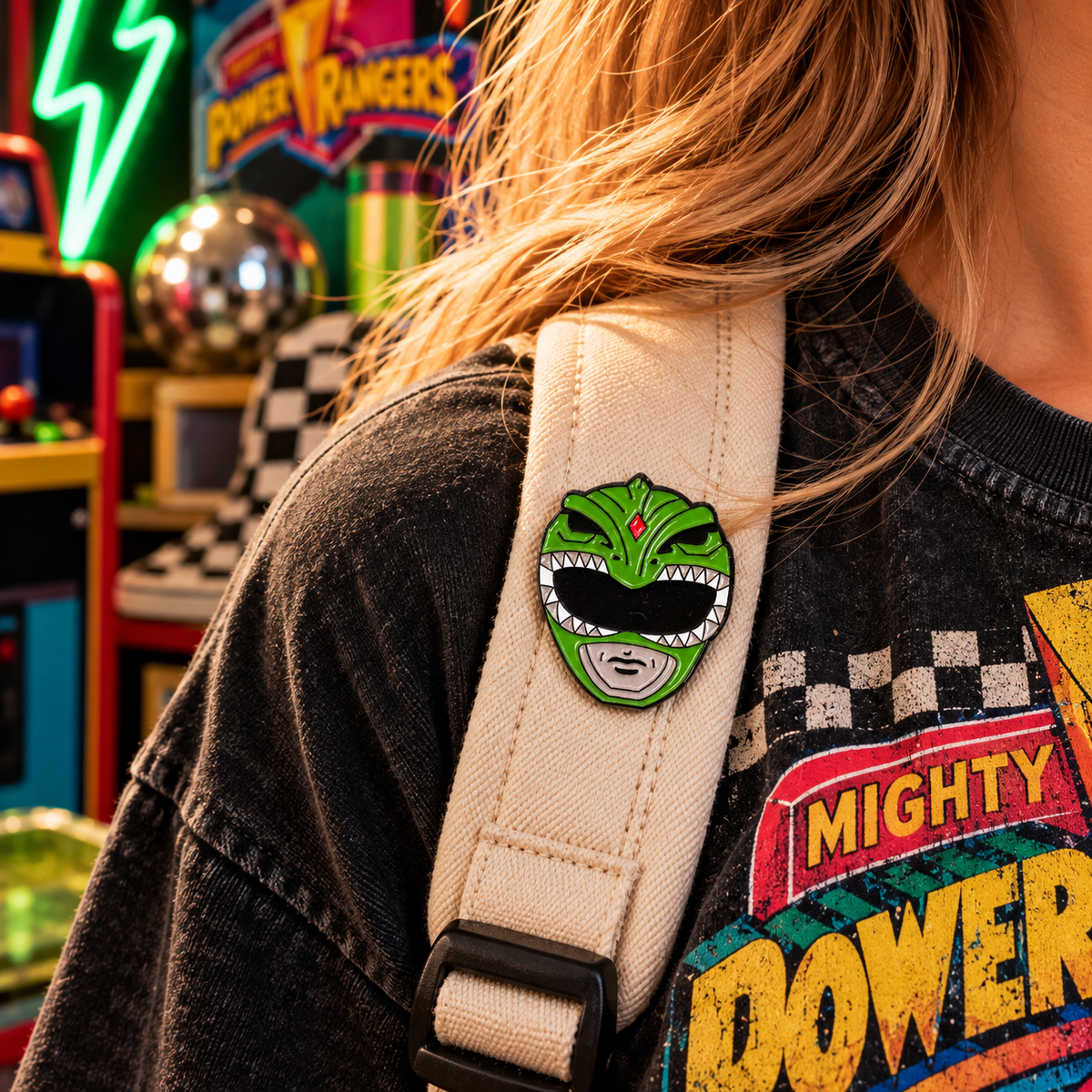 Green Ranger inspired helmet enamel pin worn on a cream canvas backpack strap