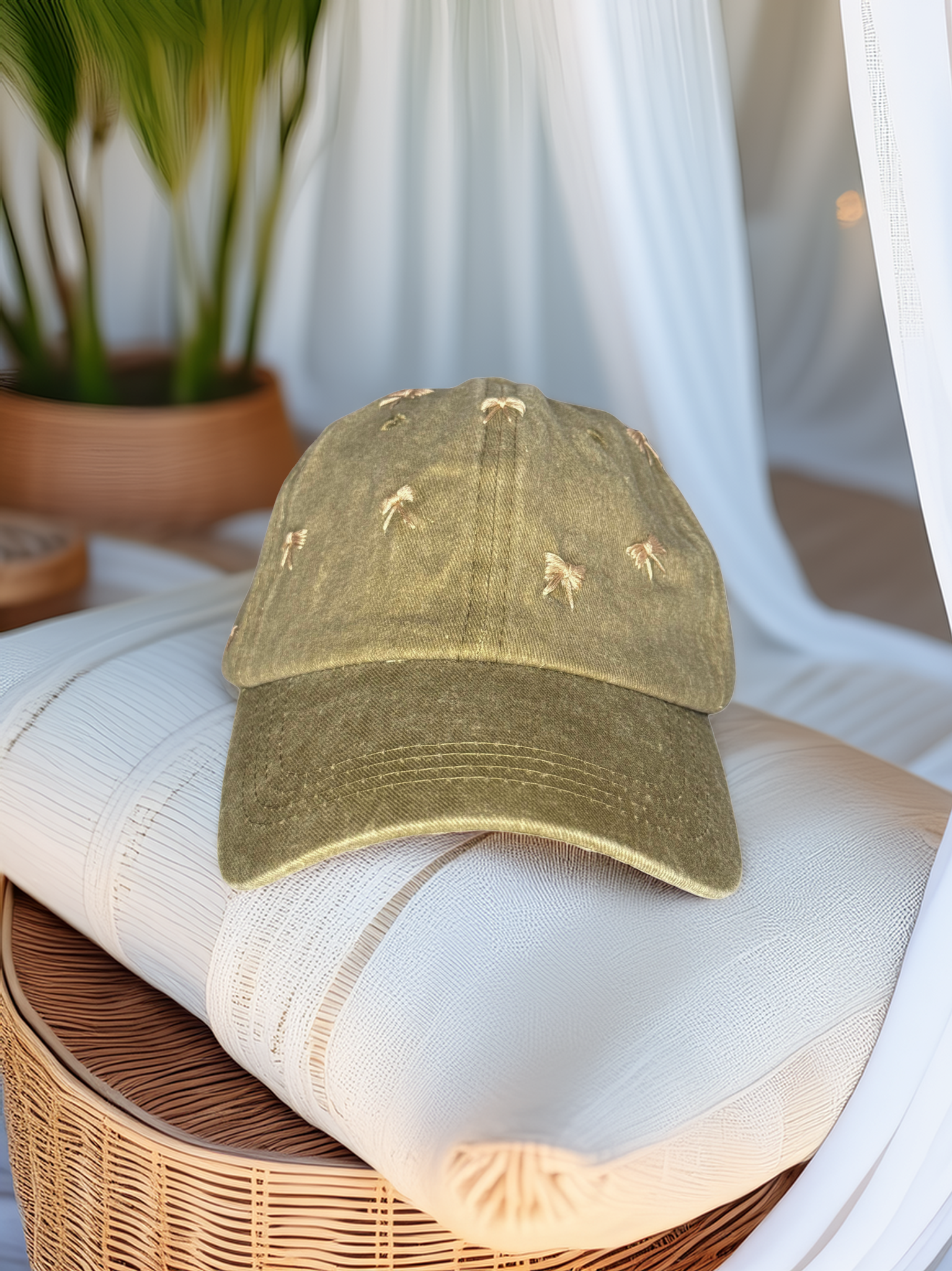 Green cap with embroidered designs on a white cushion