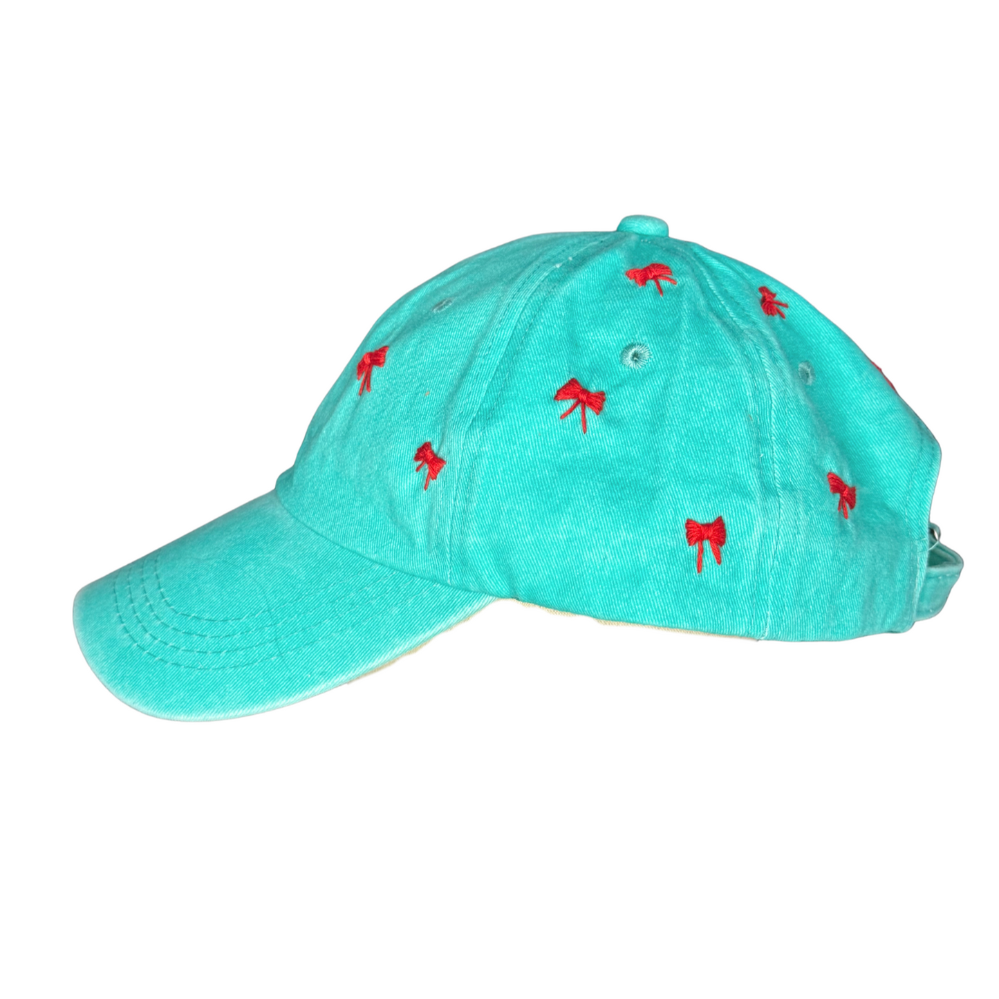 Turquoise cap with red bow patterns on a white background