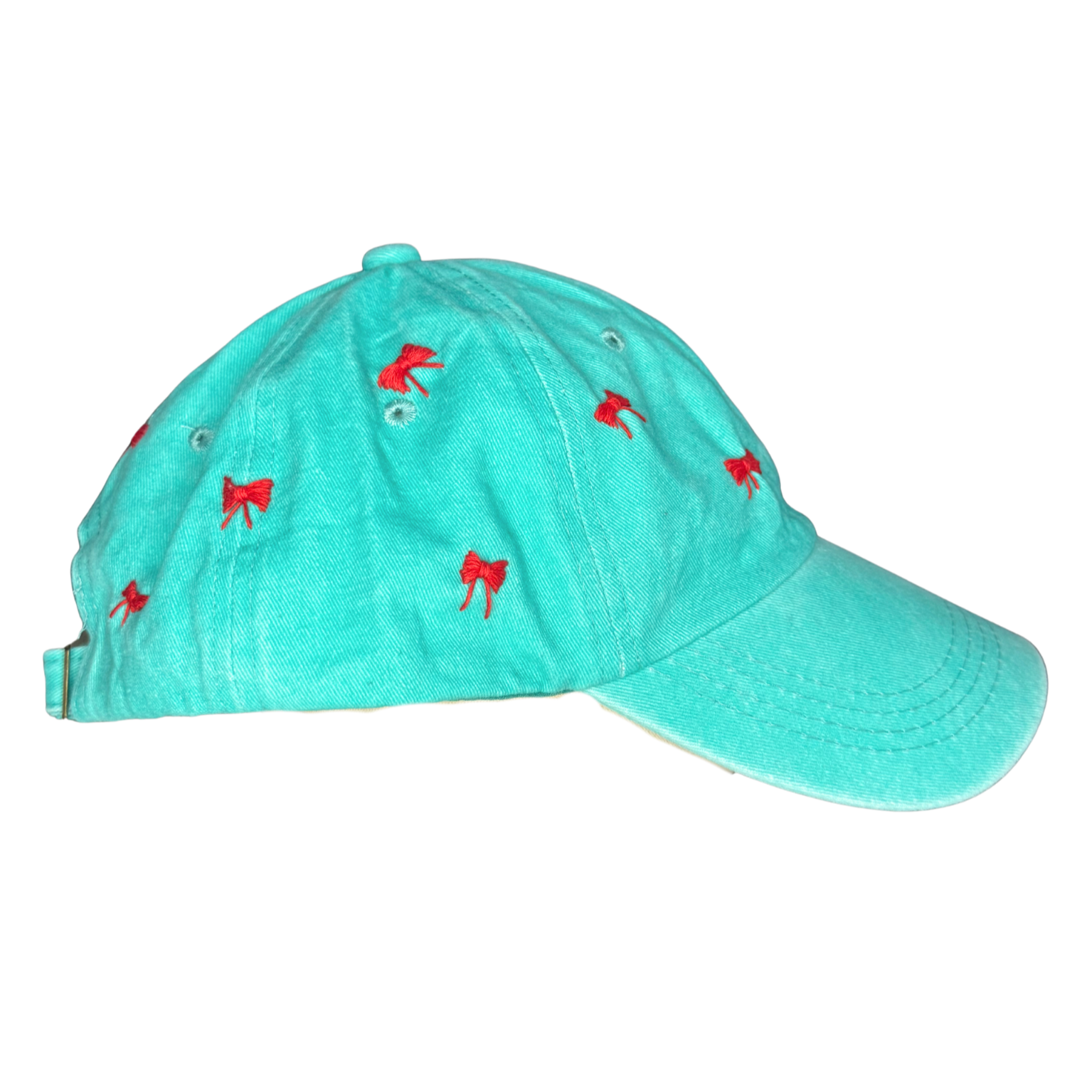Turquoise cap with red embroidered designs on a white background