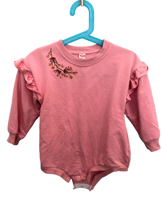 Pink baby romper with ruffled sleeves on a blue hanger against a white background