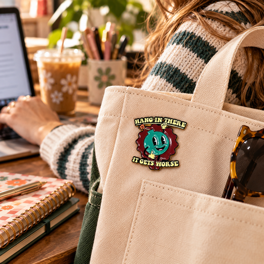Hang In There It Gets Worse enamel pin on canvas tote lifestyle image
