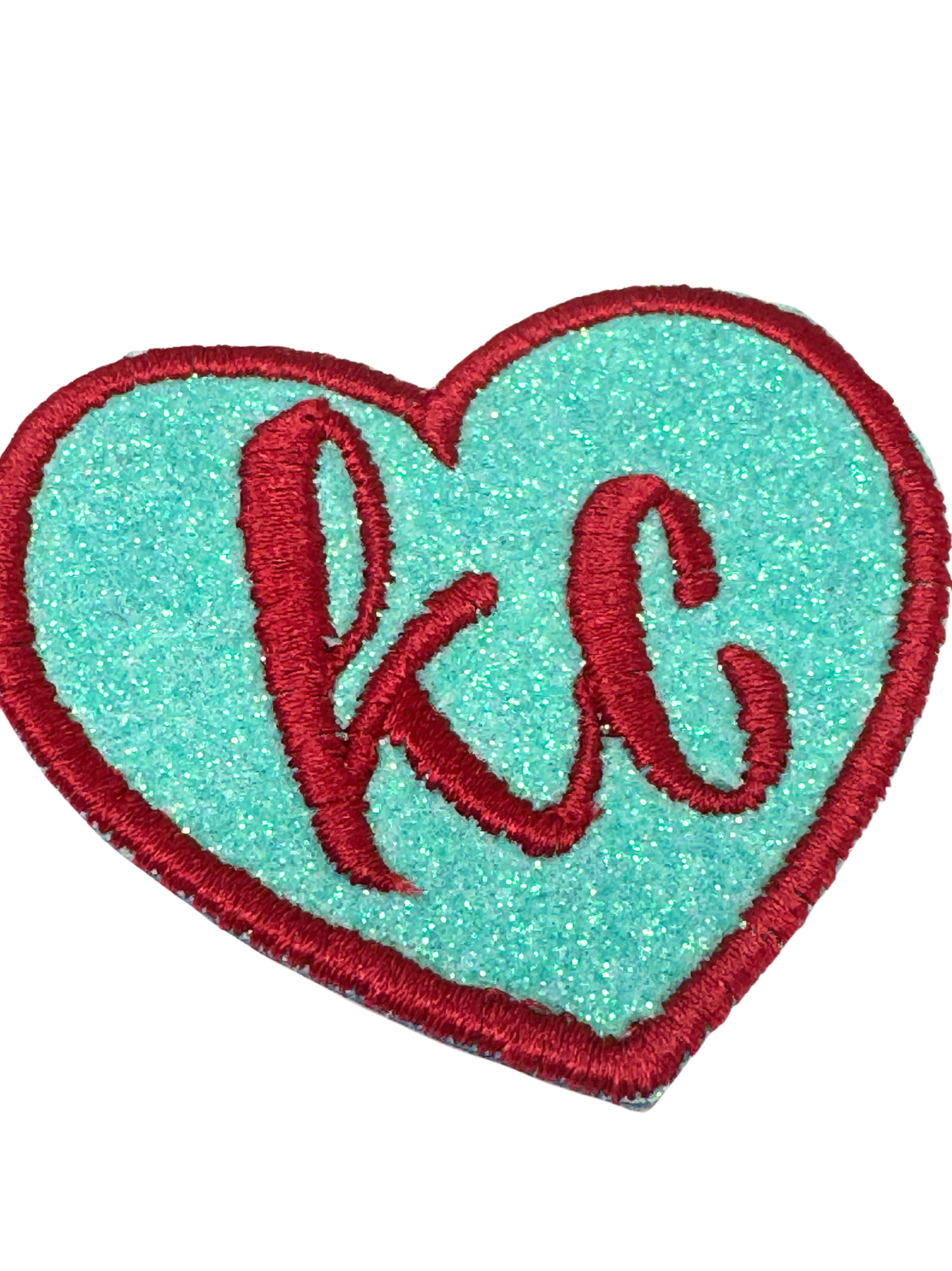 Close-up of glittery KC patch showing texture and detail

