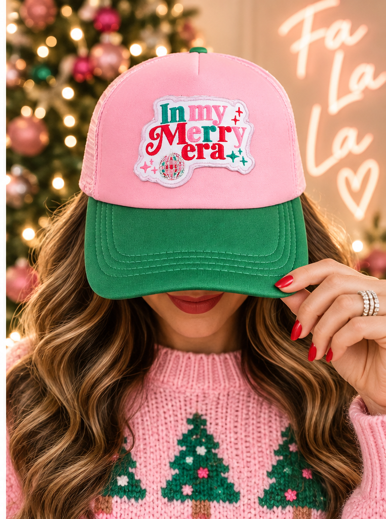 Model wearing In My Merry Era pink and green trucker hat