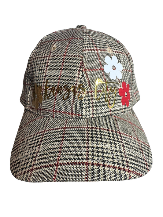 Plaid patterned cap with embroidered text and flowers on a white background