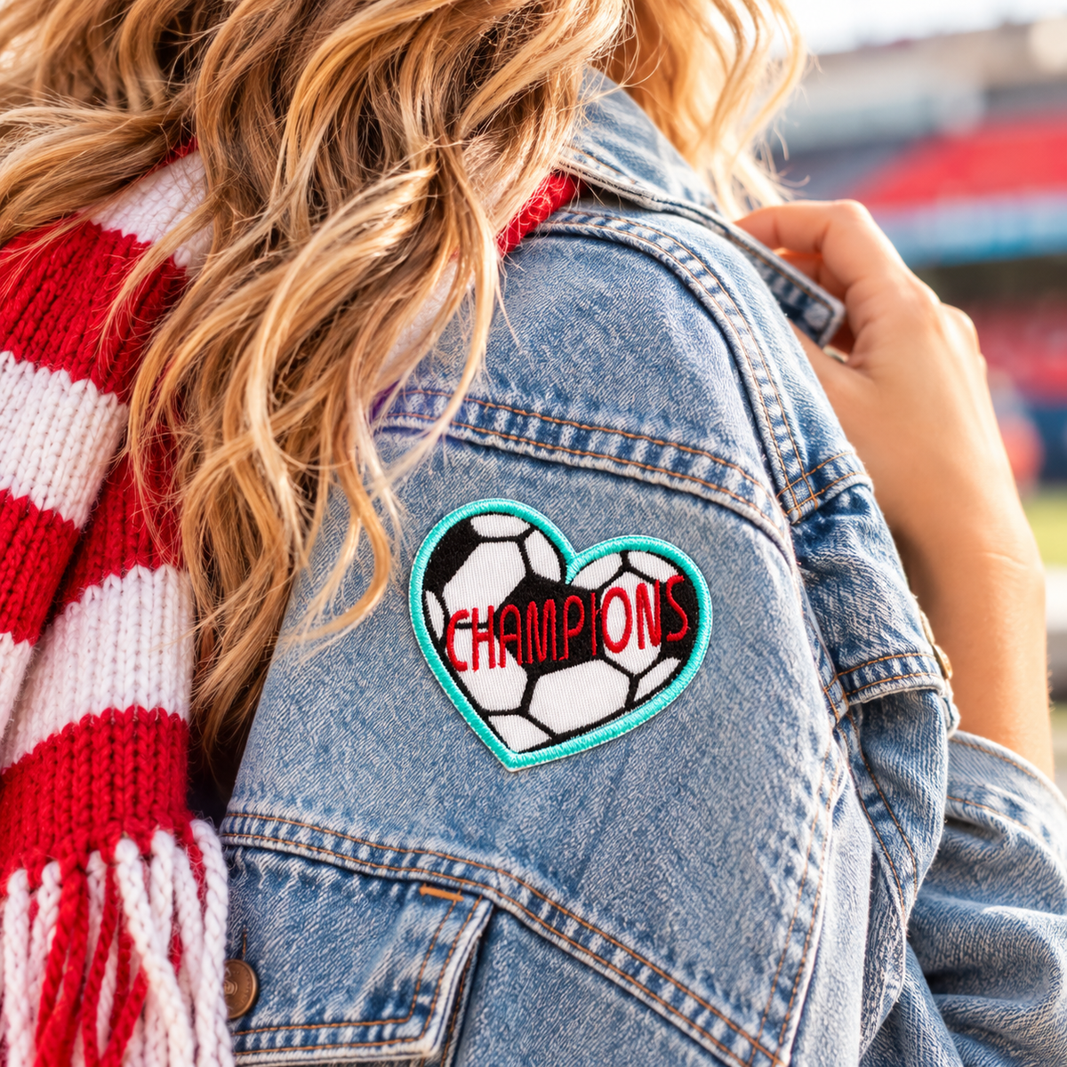 Champions soccer heart embroidered patch styled on a denim jacket