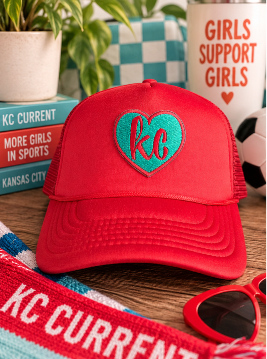Red and teal KC Current heart trucker hat styled with soccer-inspired Kansas City details