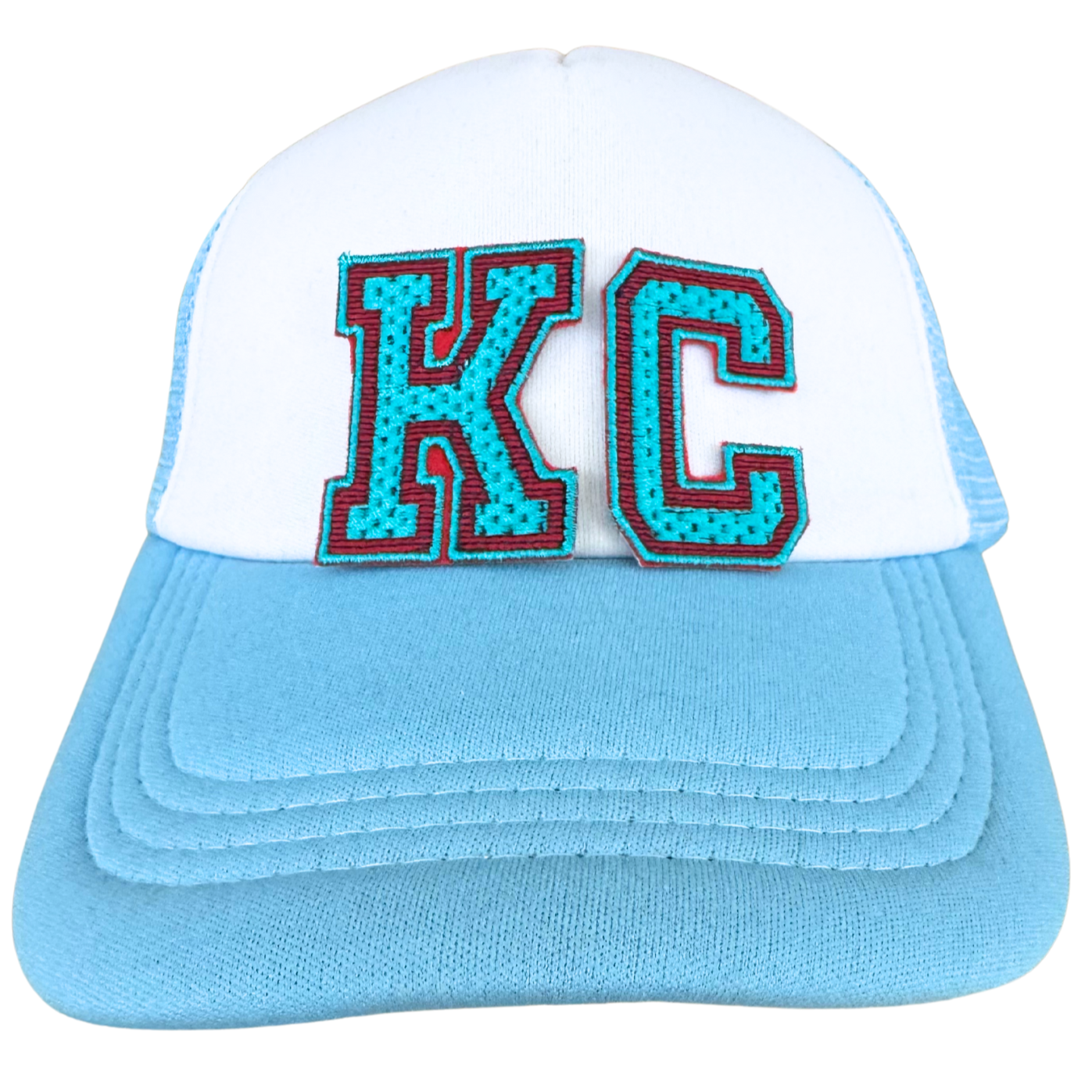 Trucker hat featuring teal KC varsity chenille patch with red and black trim, inspired by KC Current

