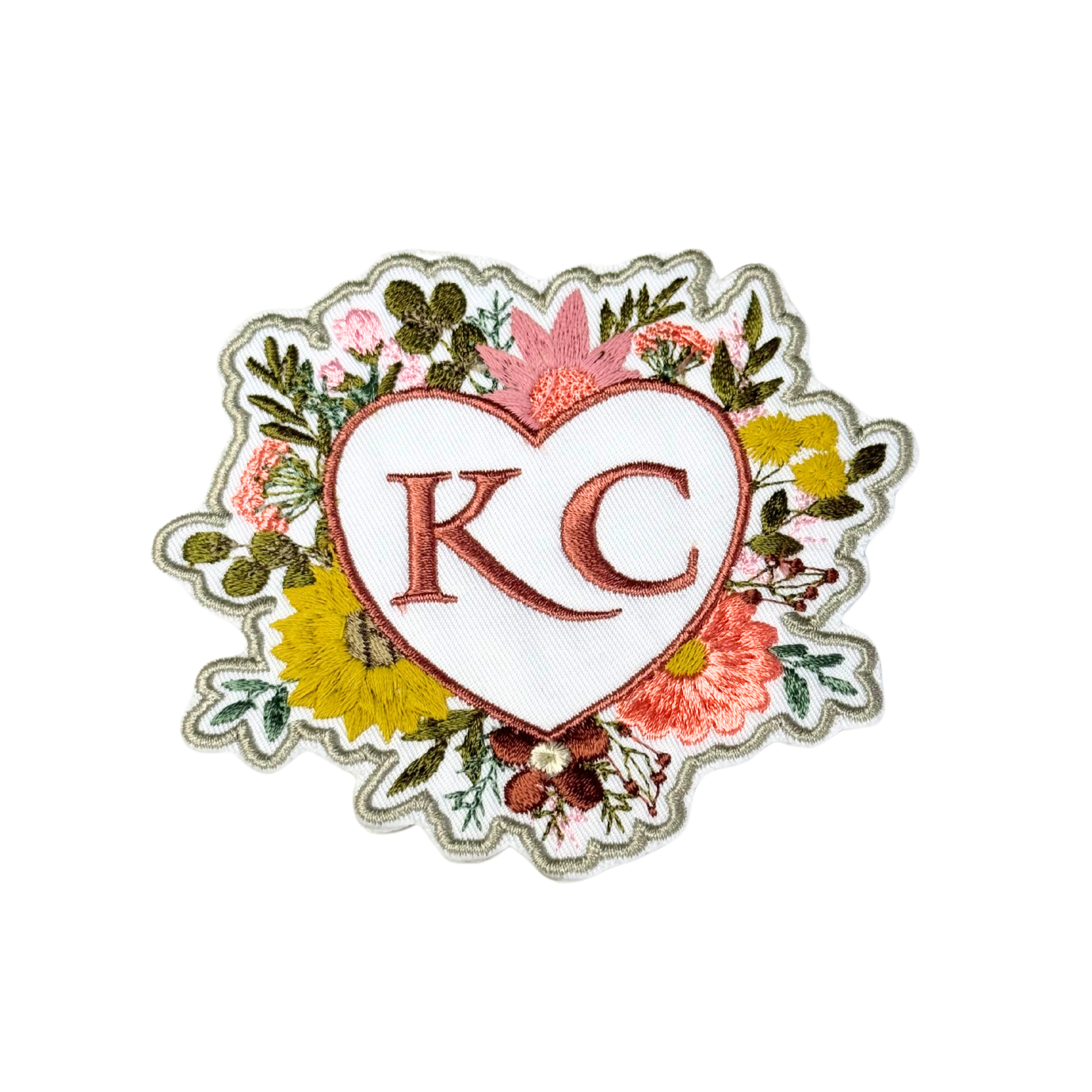 Embroidered floral heart KC patch, detailed closeup showing colorful embroidery.