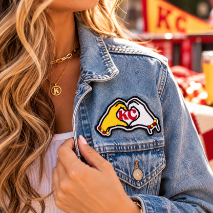 KC Heart Hands iron-on patch styled on denim jacket