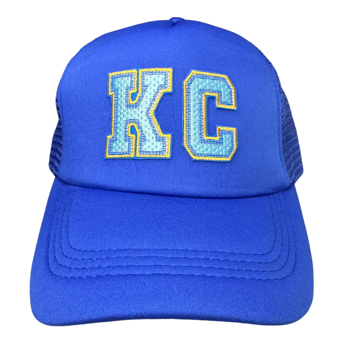 Front view of all royal blue trucker hat with light blue and gold embroidered KC patch

