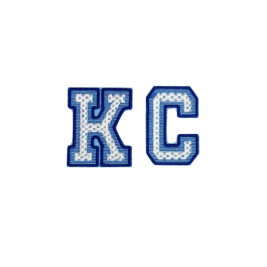 Iron-on chenille patch reading “KC” in varsity-style blue and white letters
