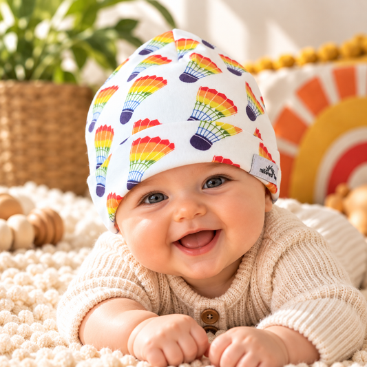Baby wearing rainbow shuttlecock print Kansas City organic cotton beanie
