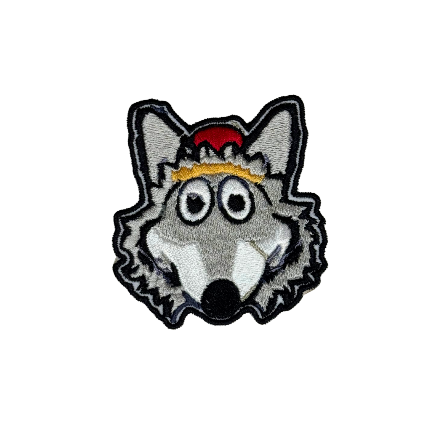 Close-up of embroidered KC Wolf iron-on patch on white background